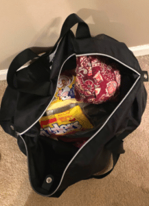 Photo shows the inside contents of a hospital bag including clothing and snacks.
