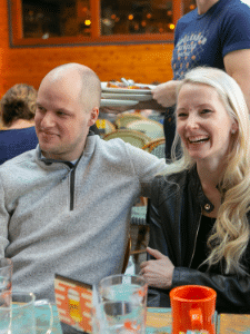 James and Kate smile at a restaurant